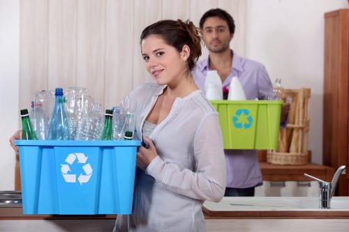 Business staff placing items into clearly labelled recycling containers